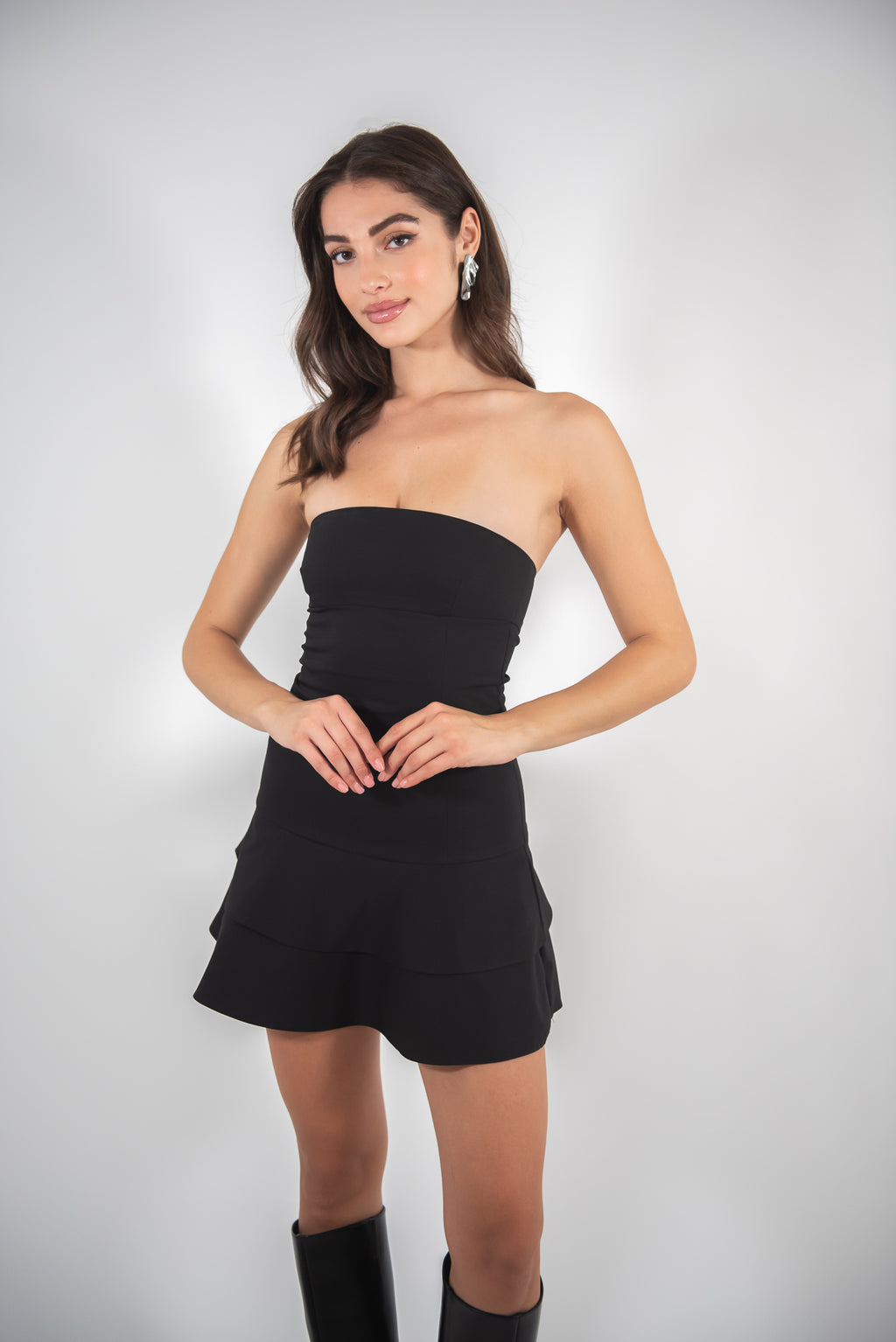 Woman wearing black dress, full-body front view