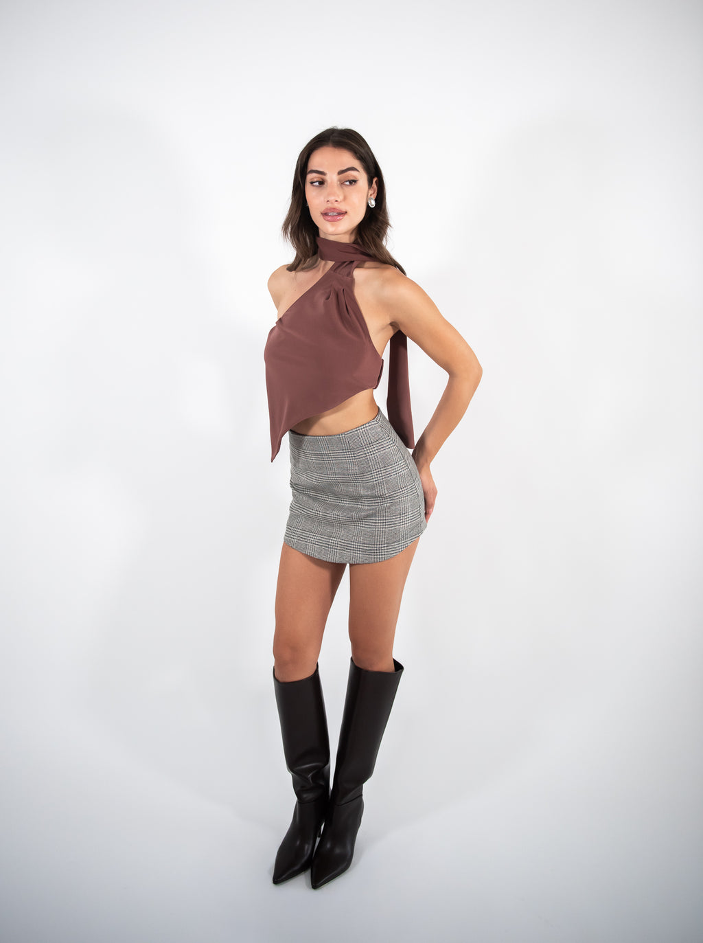 Woman wearing a checkered skirt, full-body view