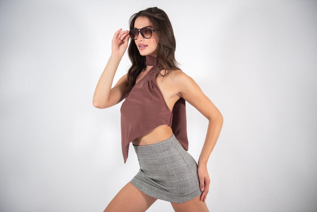 Woman posing in a checkered skirt.