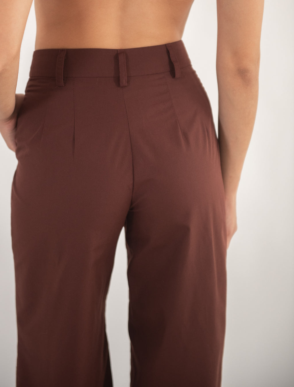 Woman wearing brown pants, close-up back view