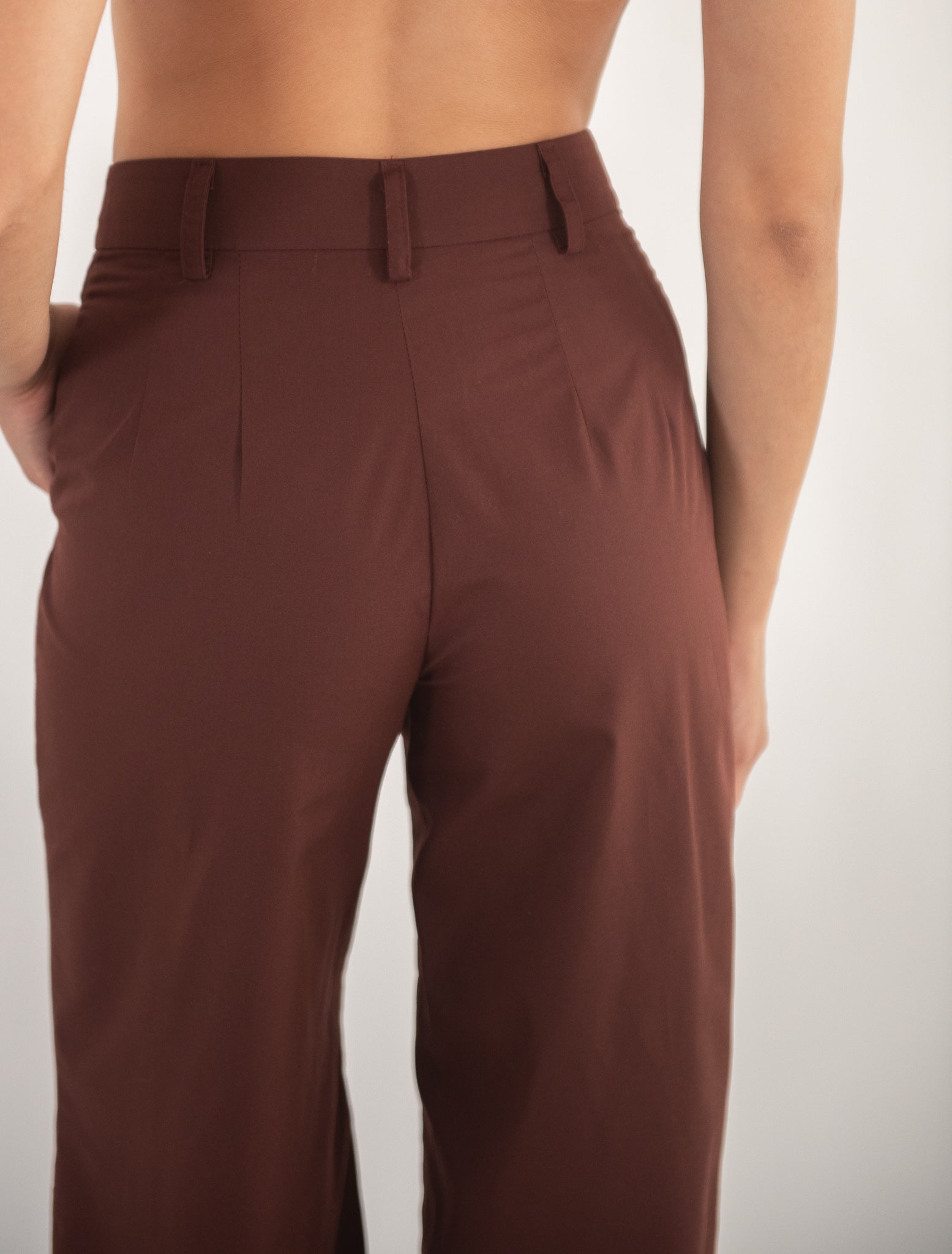 Woman wearing brown pants, close-up back view