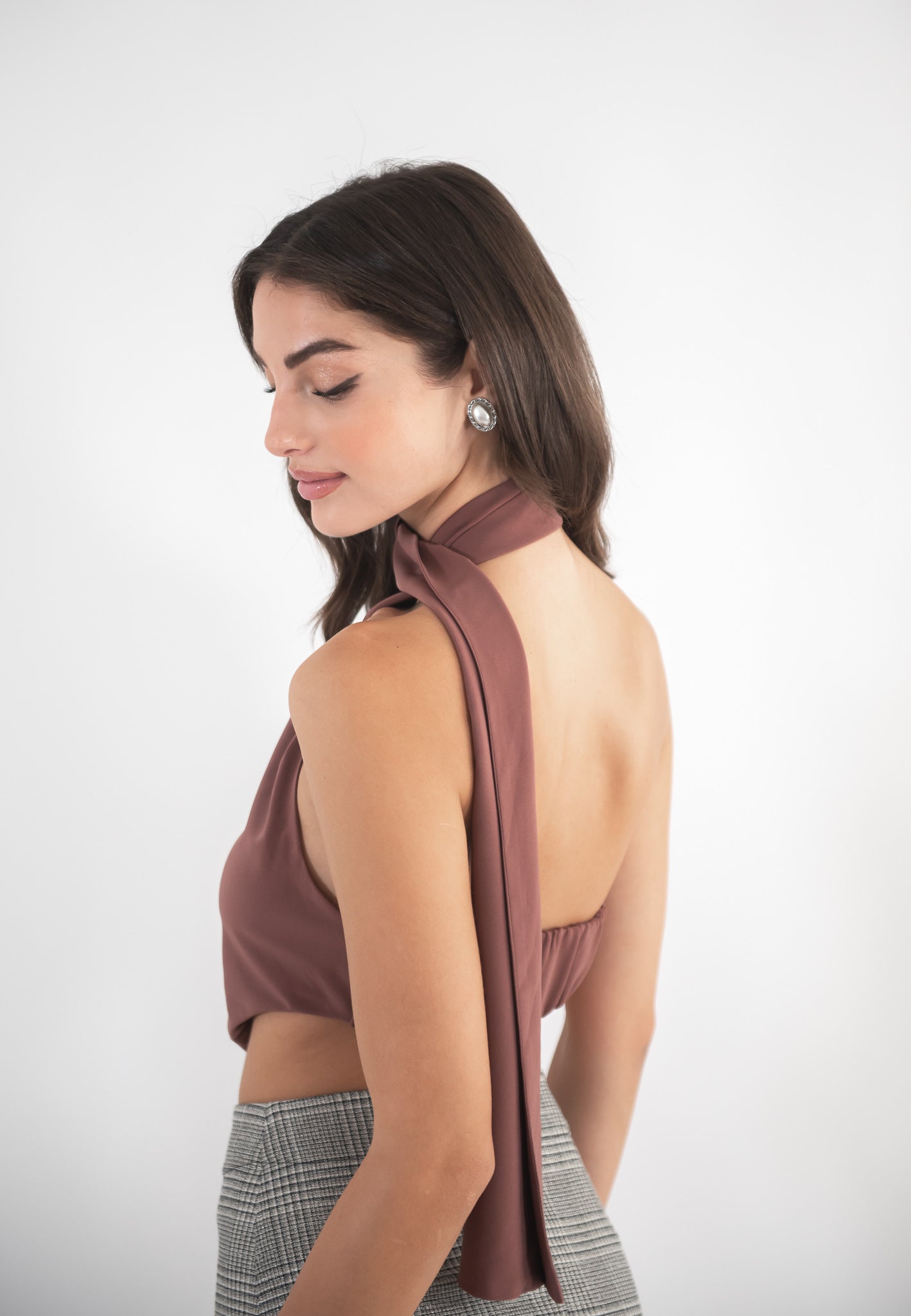 Woman wearing a brown top, back view