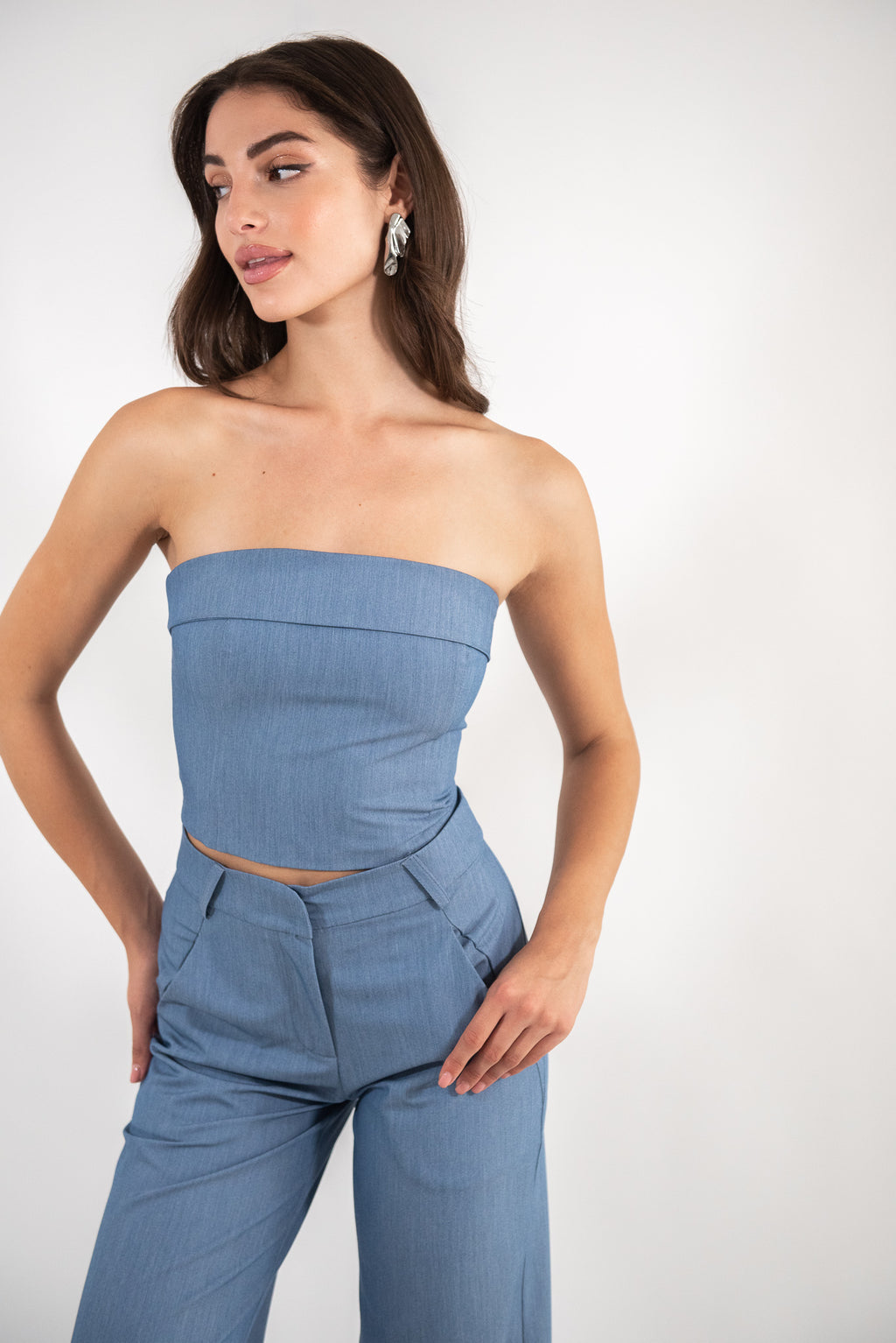 Woman wearing a blue top, front view.